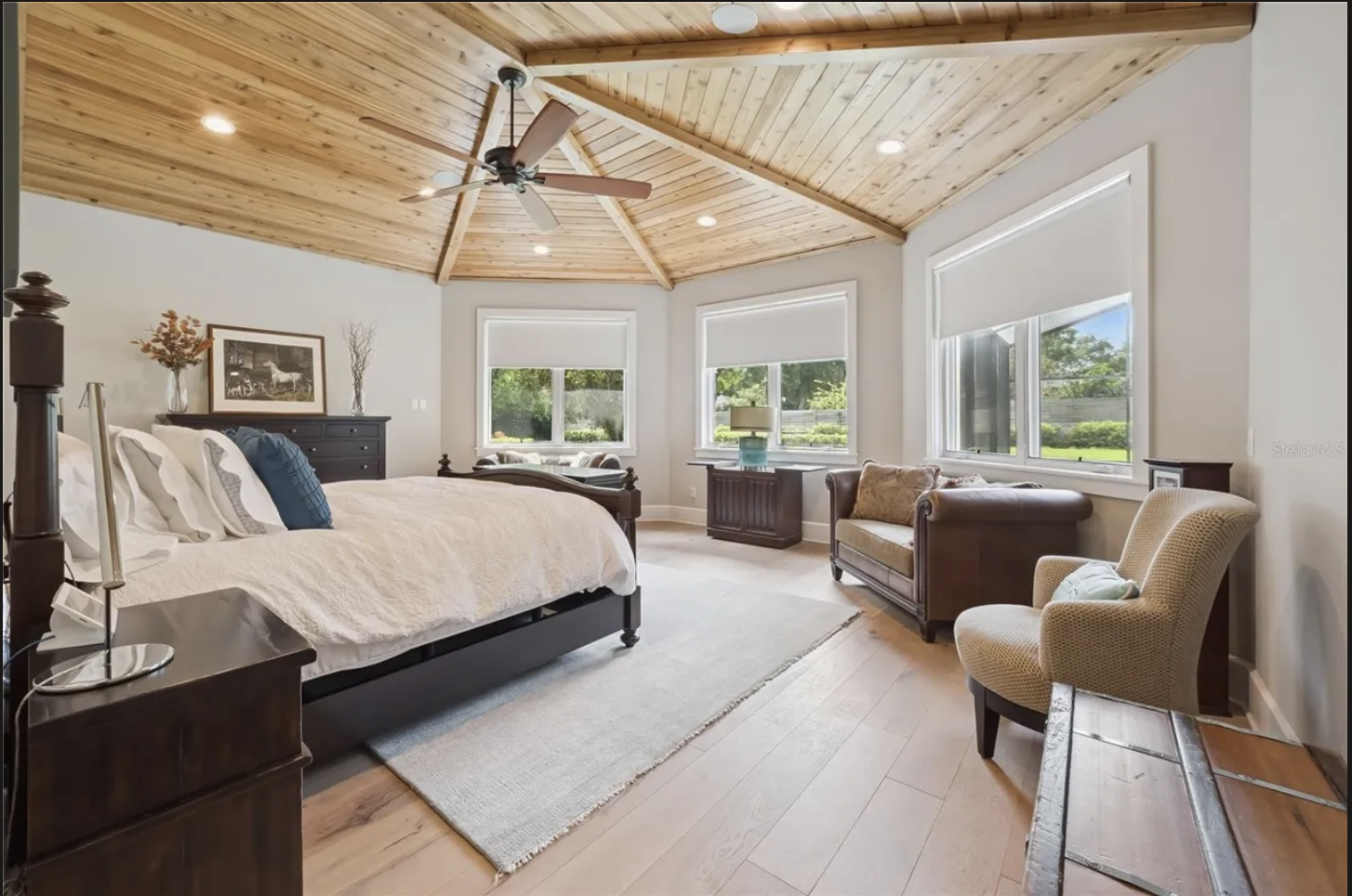 Primary bedroom with vaulted wood ceiling