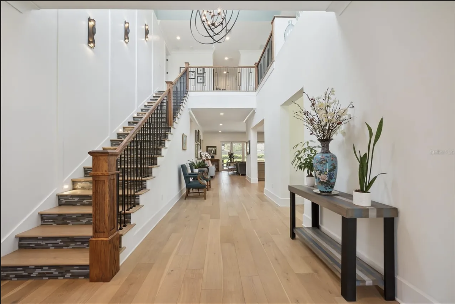 Two-story entry foyer with wood staircase