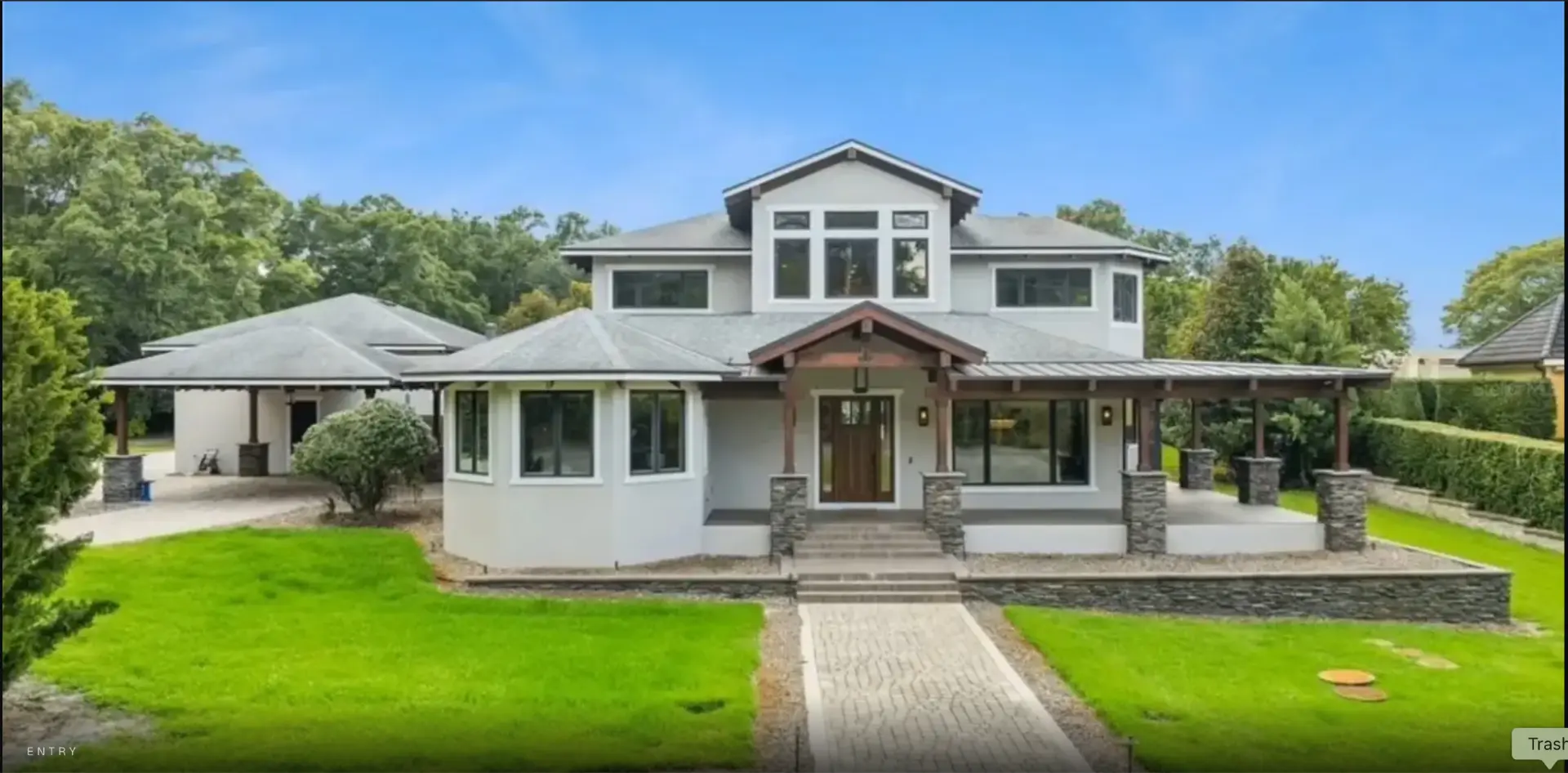 Front exterior of the home with covered entry and paver walkway