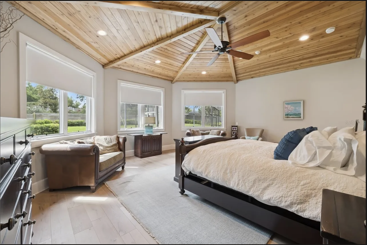 Reverse view of the primary bedroom and vaulted wood ceiling